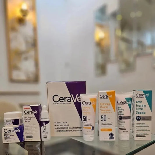 CeraVe skincare products displayed on a glass surface with a blurred indoor background.